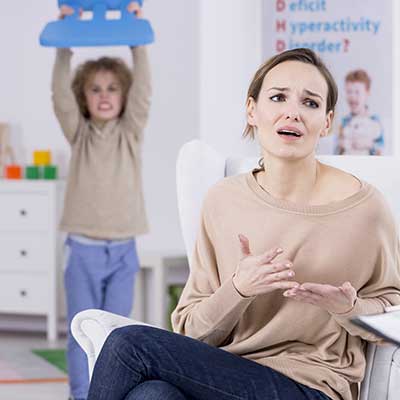 adhd-boy-with-chair-above-head-by-mother-image-vanguard-psychiatry